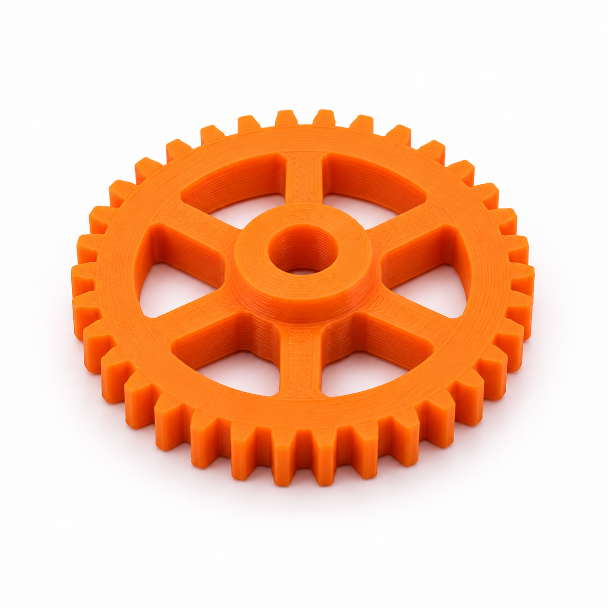 Orange 3D-printed mechanical gear on white